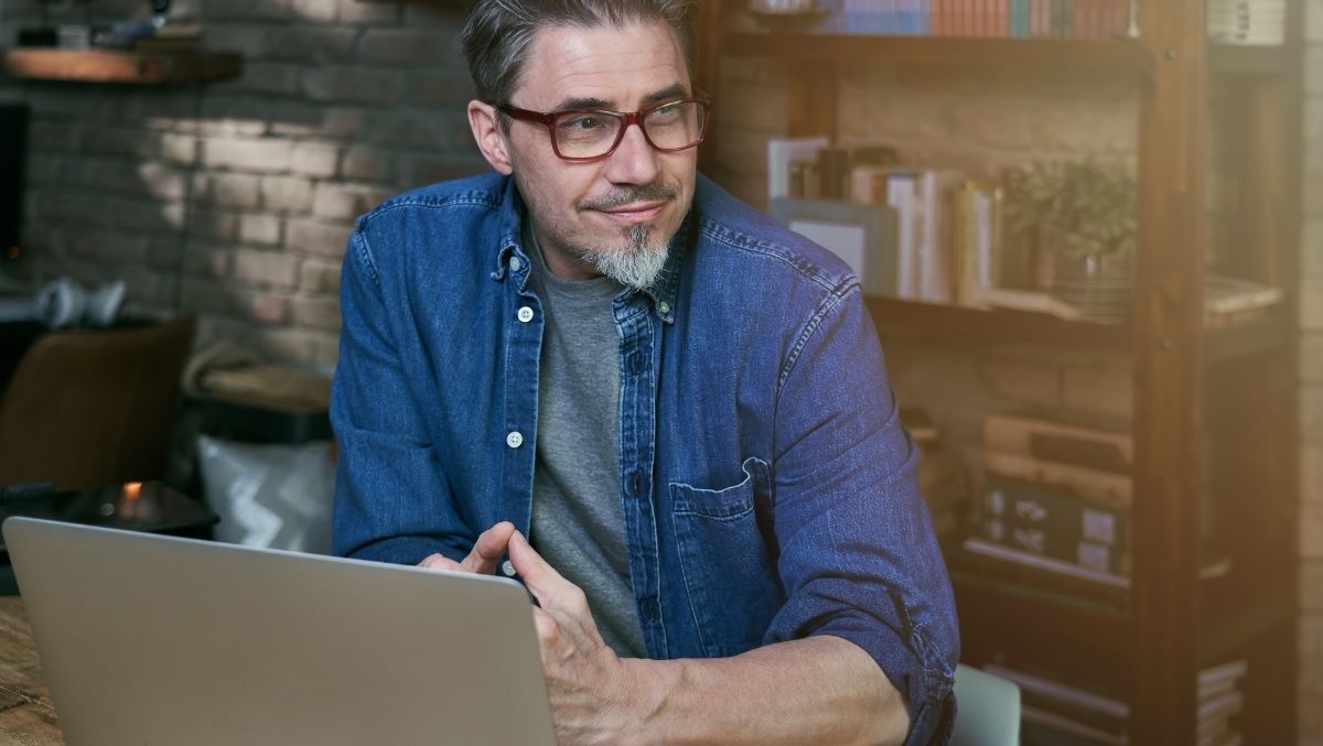 Man sitting at desk with laptop